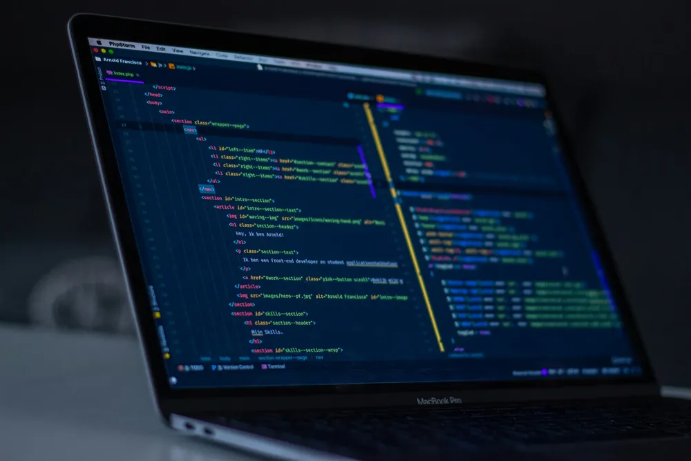 Code editor open on a laptop in a dark room